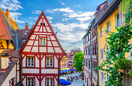 Medieval half-timbered houses old colorful buildings and people relax on Tiergartnertor Square in old town Nuremberg city historical center, Middle Franconia region, Bavaria state, Germany